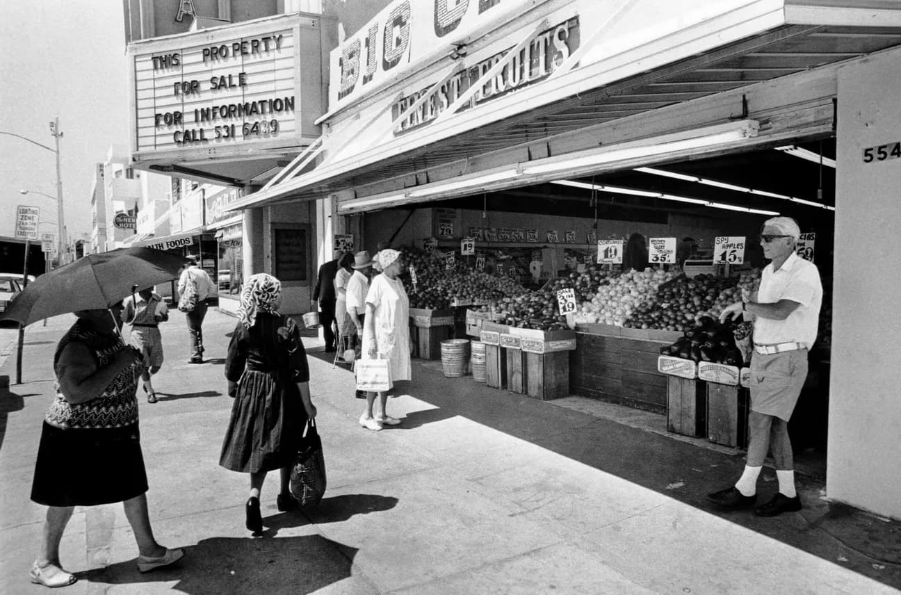 Patrons drop by a grocery store, 1970. 